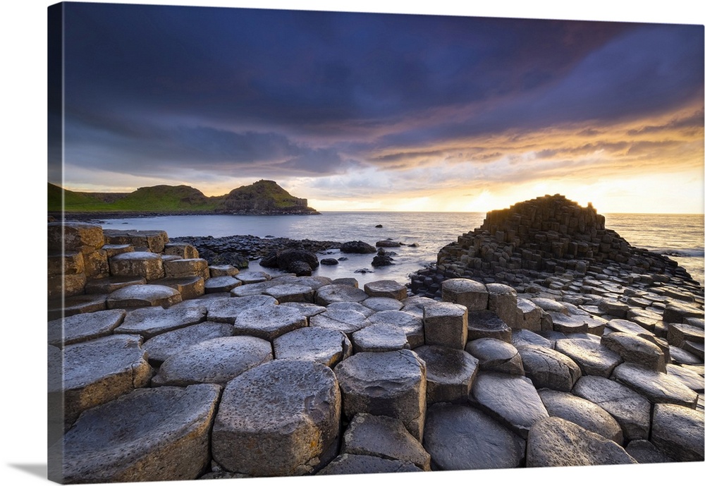 An epic sunset at the Giant's Causeway with it's iconic basalt columns. County Antrim, Ulster region, Northern Ireland, Un...