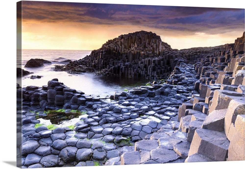 An epic sunset at the Giant's Causeway with it's iconic basalt columns. County Antrim, Ulster region, Northern Ireland, Un...