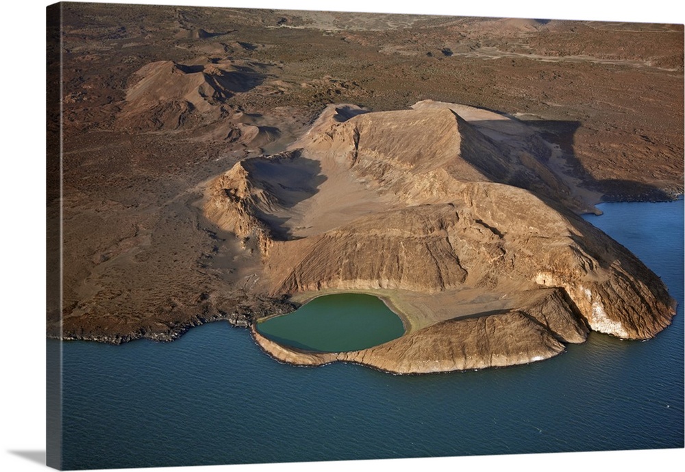 An extinct volcanic crater, Abil Agituk, at the southern end of Lake Turkana has a distinctively green crater lake which i...
