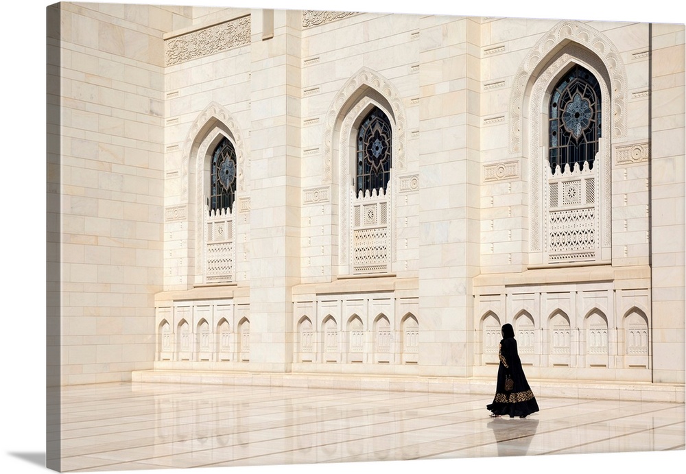 An Omani Woman Walks Past The Marble Facade Of Sultan Qaboos Grand Mosque, Muscat, Oman.