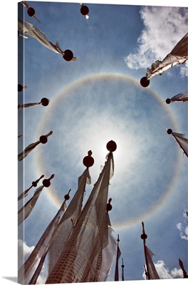 An unusual full circle rainbow phenomenon surrounded by lungdhar Buddhist prayer flags
