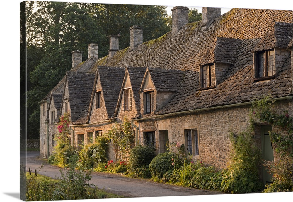 Picturesque cottages at Arlington Row in the Cotswolds village of Bibury, Gloucestershire, England. Summer (July)