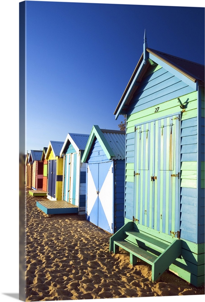 Australia, Victoria, Melbourne. Colourful beach huts at Brighton Beach.