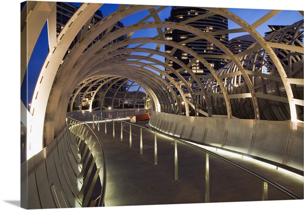 Australia, Victoria, Melbourne, Docklands. The Webb Dock Bridge at night, its design inspired by Koorie fish traps.