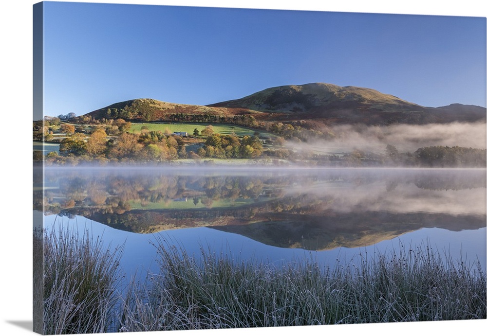 Autumnal reflections on a frosty morning at Loweswater in the Lake District National Park, Cumbria, England. Autumn (Novem...