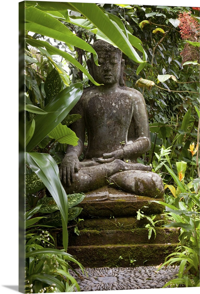 Bali, Ubud. A statue of Budda sits serenely in gardens.