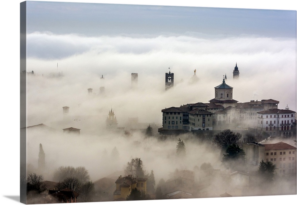 Bergamo, Lombardy, Italy. Foggy sunrise over high city.
