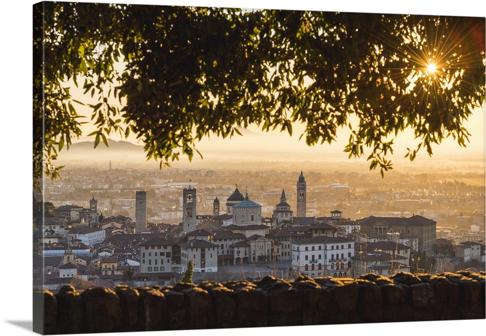 Bergamo, Lombardy, Italy. High angle view over Upper Town (Citta Alta) at sunrise.