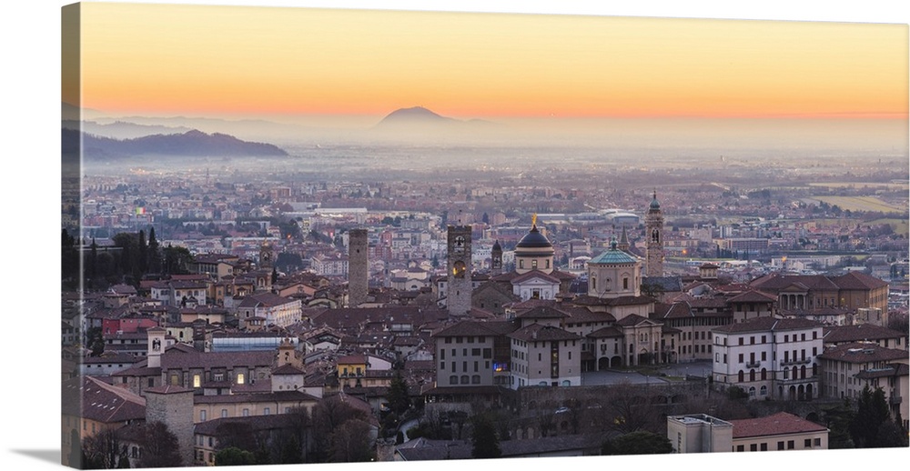 Bergamo, Lombardy, Italy. High angle view over Upper Town (Citta Alta) at sunrise.
