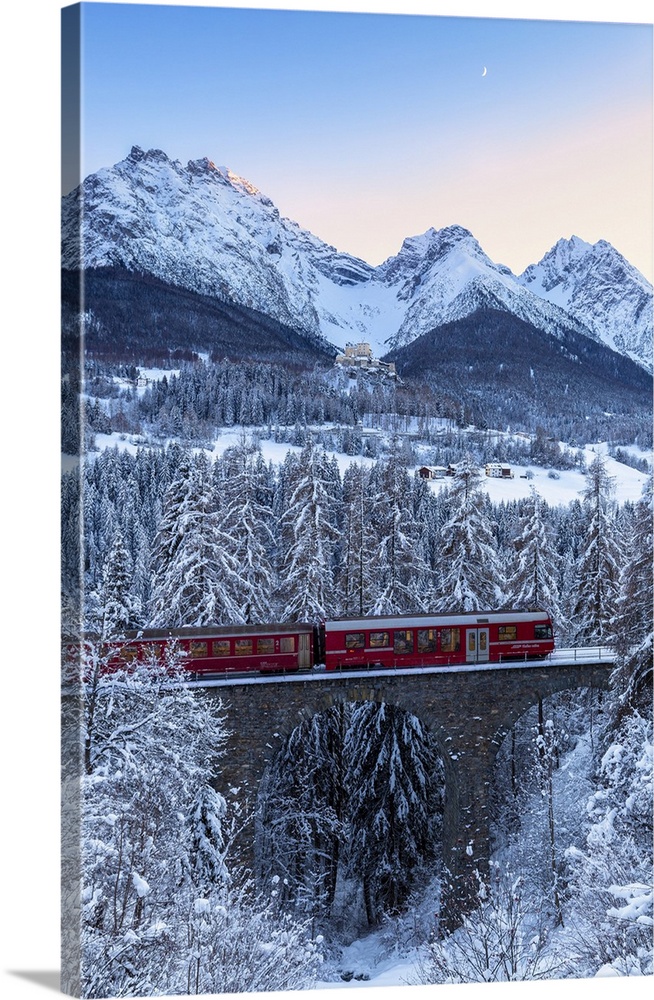 Bernina Express transit on the viaduct in winter. Lower Engadine, Canton of Grisons, Switzerland, Europe.