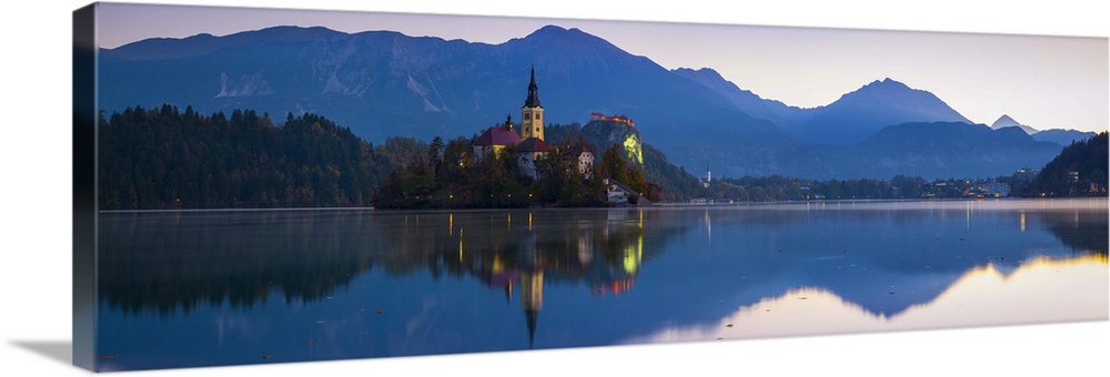 Bled Island (Blejski otok) with the Church of the Assumption (Cerkev Marijinega vnebovzetja) illuminated at dawn, Lake Ble...