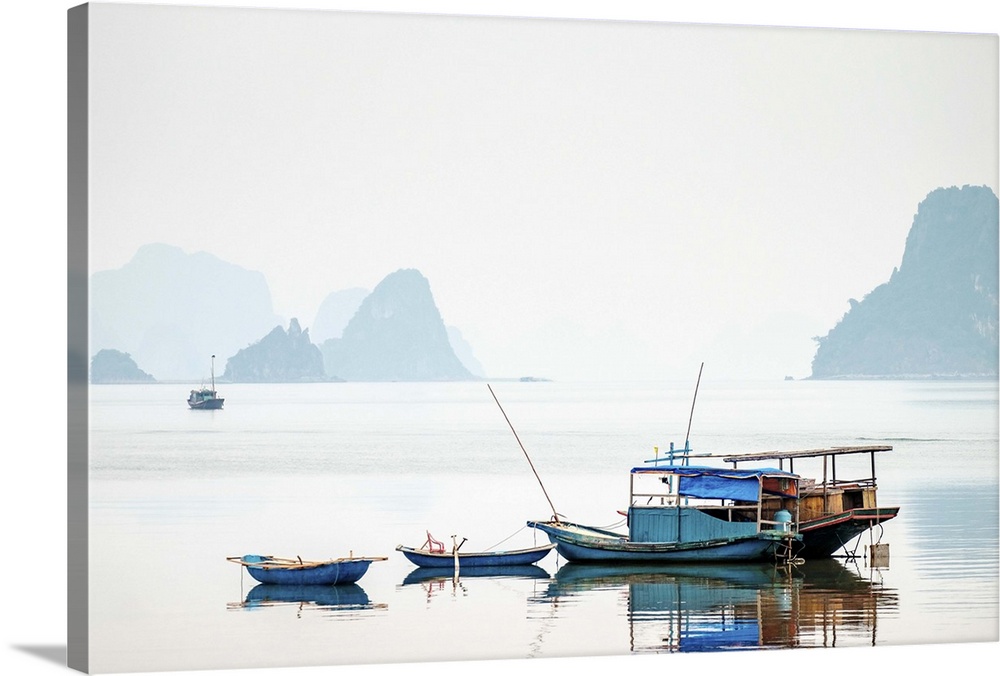 Boats in Bai Tu Long Bay on a foggy day, Cai Rong, Quang Ninh Province, Vietnam.