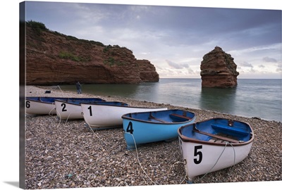Boats pulled up on the shingle at Ladram Bay on the Jurassic Coast, Devon, England