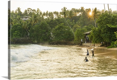 Boys playing in surf, Mirrisa beach, South coast, Sri Lanka