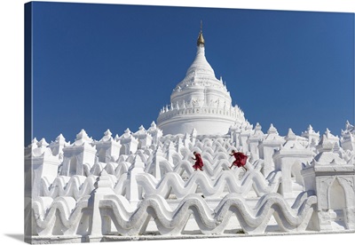 Buddhist monks on the white walls of Hsinbyume Pagoda, Mandalay, Myanmar
