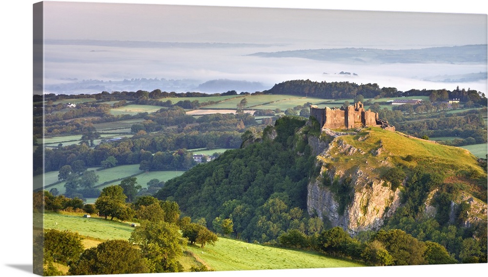 Carreg Cennen Castle at dawn on a misty summer morning, Brecon Beacons National Park, Carmarthenshire, Wales, UK. Summer, ...