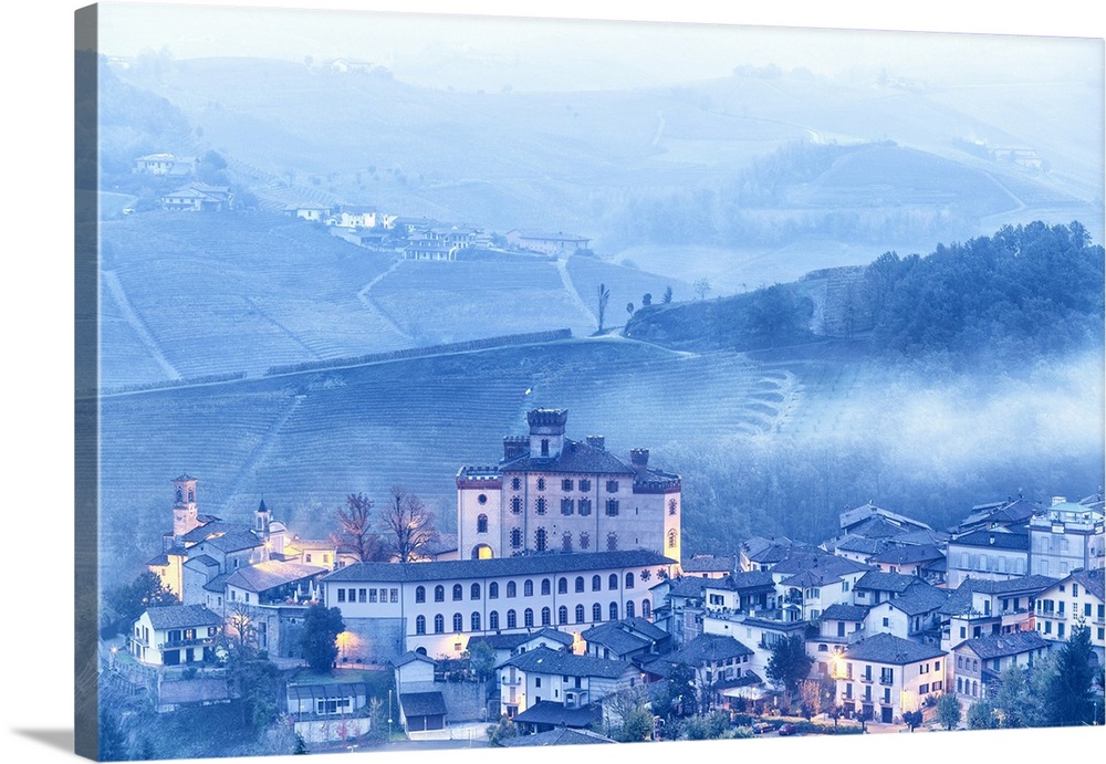 Castle and village of Barolo during a foggy dusk. Barolo wine region, Langhe, Piedmont, Italy, Europe.