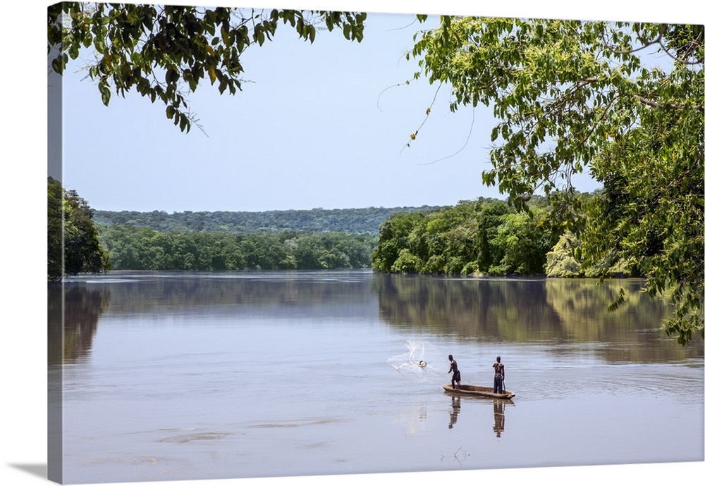 Central African Republic, Bayanga, Sangha River. Sangha-Sangha fishermen cast a large net to catch fish in the Sangha River.