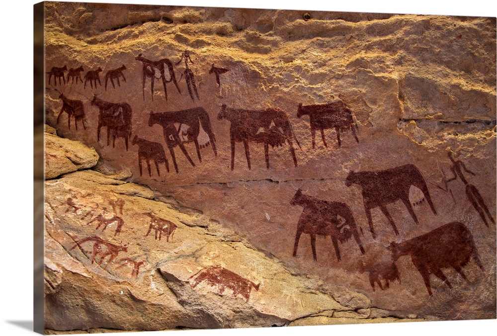 Chad, Taore Koaole, Ennedi, Sahara. Bichrome paintings of cattle and two human figures decorate the sandstone wall of a cave.