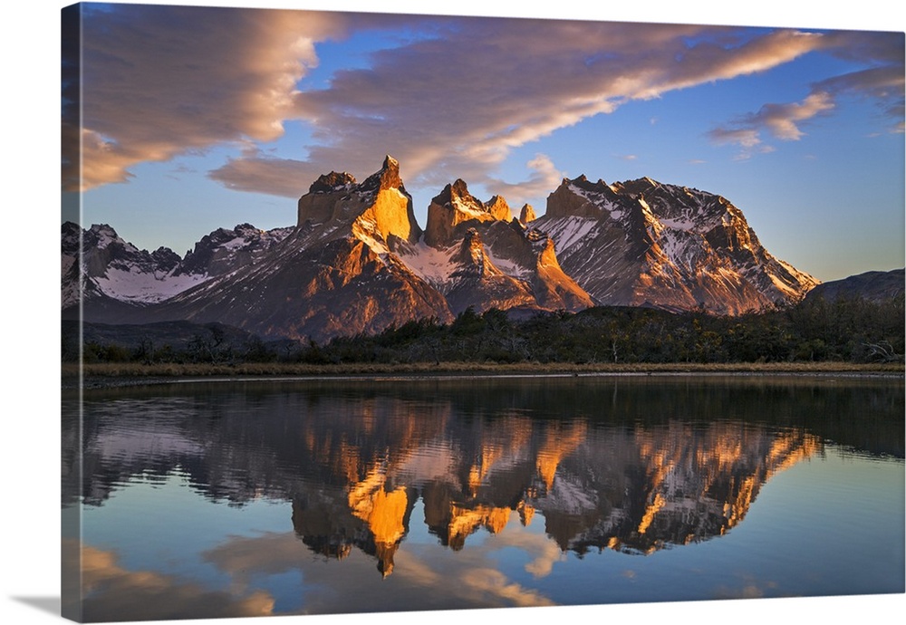Chile, Torres del Paine, Magallanes Province. Sunrise over Torres del Paine reflected in the waters of Lake Pehoe in the f...