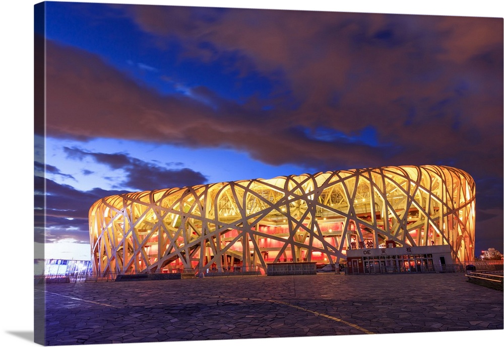 China, Beijing, Olympic park and famous bird's nest stadium made of steel illuminated by a colorful sunset.