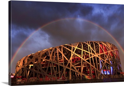 China, Beijing, Olympic park and stadium illuminated by a colorful sunset with a rainbow