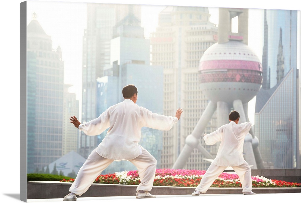 China, Shanghai. Chinese men practising Tai Chi on the Bund (MR)