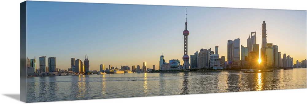 China, Shanghai, Pudong District, Skyline of the Financial District across Huangpu River at sunrise