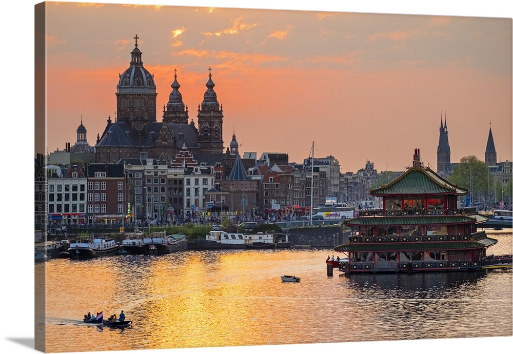 Netherlands, North Holland, Amsterdam. City skyline at sunset with domes of Basilica of Saint Nicholas.