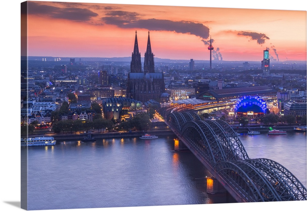 Cologne Cathedral and Hohenzoller Bridge over River Rhine in Cologne city at dusk. Cologne city (Koln), North Rhine Westph...