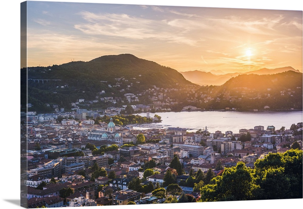 Como, Lombardy, Italy. High angle view over the city and the Como Cathedral at sunset.