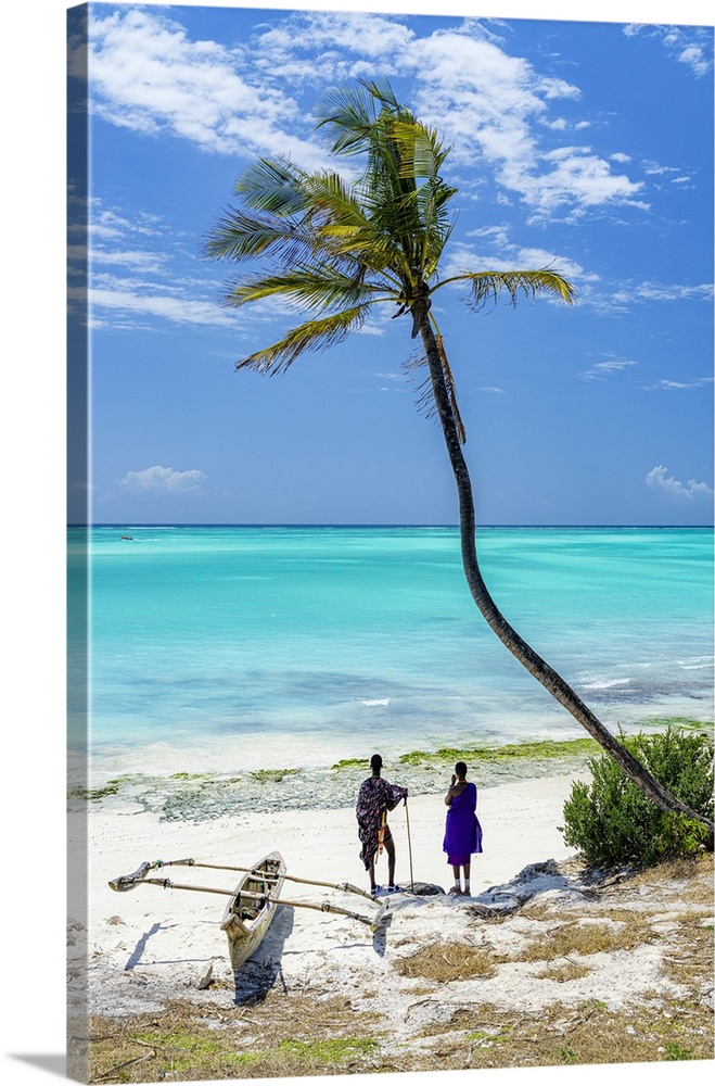 Couple of Maasai with dhow admiring the crystal sea standing on a palm fringed beach, Zanzibar, Tanzania (MR)