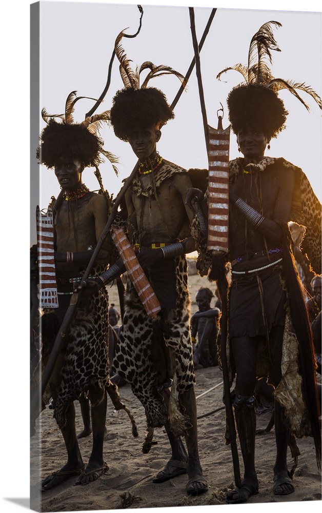 Dassanech men dressed in ceremonial regalia after participating in a Dimi dance, Ethiopia.