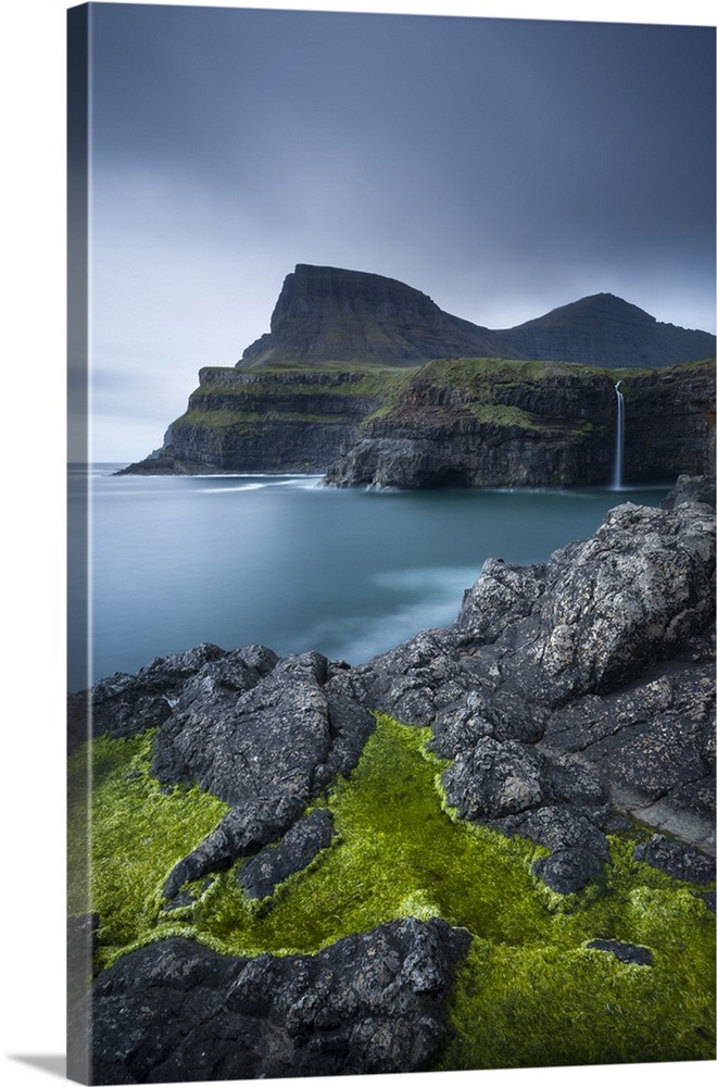 Dramatic coastline and waterfall at Gasadalur on the Island of Vagar, Faroe Islands. Spring