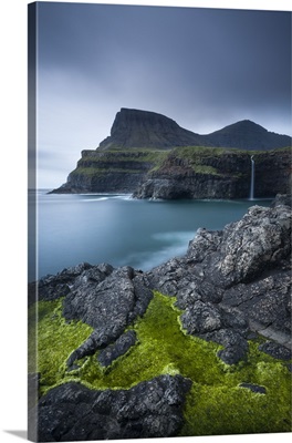 Dramatic coastline and waterfall at Gasadalur on the Island of Vagar, Faroe Islands