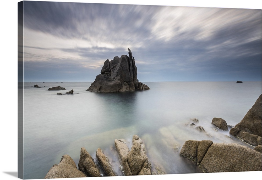 Dusk on cliffs molded by wind framing blue sea Capo Testa, Santa Teresa di Gallura, Province of Sassari, Sardinia, Italy, ...