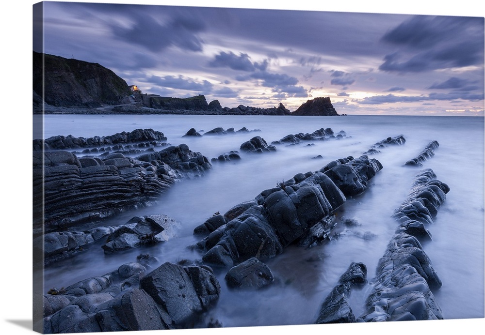 Dusk over the rugged ledges of Hartland Quay in North Devon, England.