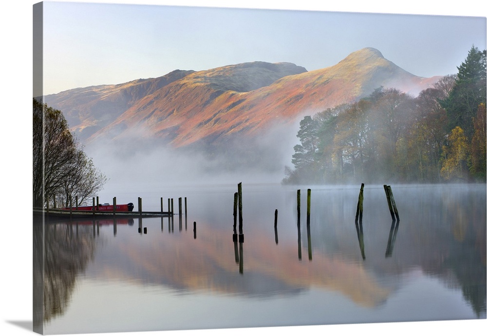 Early morning tranquil scenes of Derwent Water, with Catbells rising out of the mist in the background, Lake District Nati...