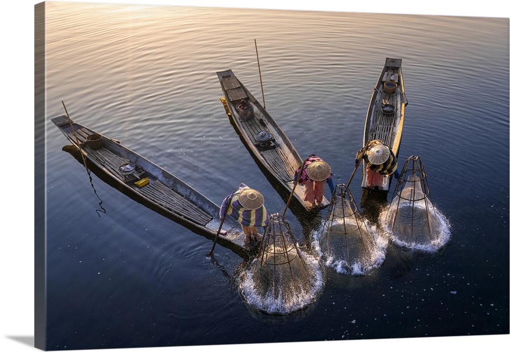 Elevated view of three fishermen catching fish from boats using traditional conical nets at sunrise, Floating Gardens, Lak...