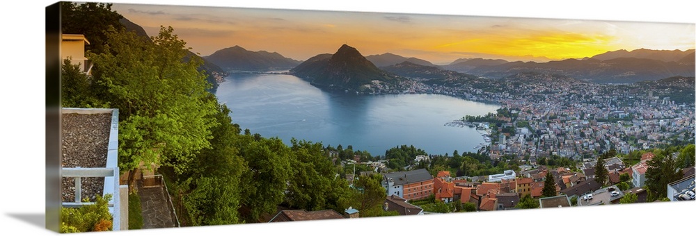 Elevated view over Lugano illuminated at sunset, Lake Lugano, Ticino, Switzerland.