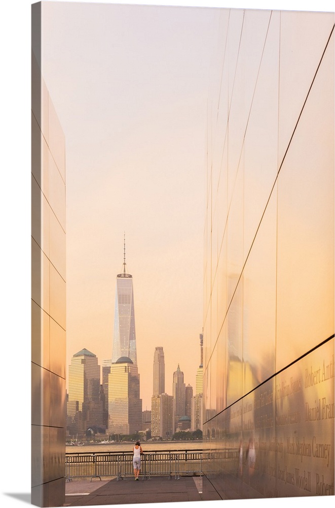 Woman enjoying the view to Manhattan from Empty skies 9/11 memorial in Liberty state park, New York, USA.