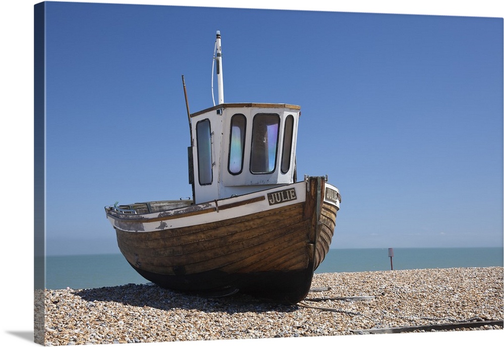 England, Kent, Deal. Old wooden fishing boat on the shingle beach at Deal.