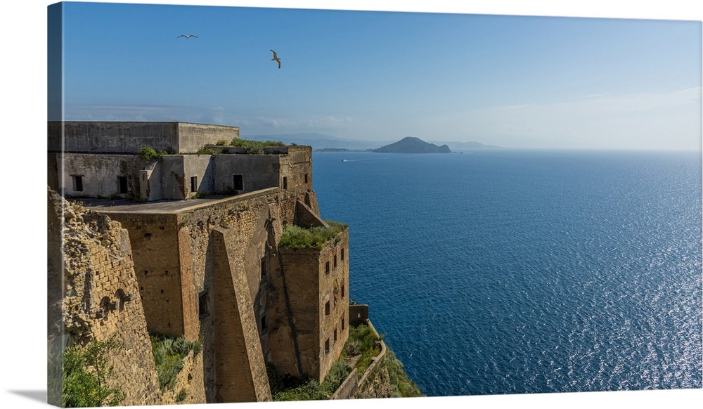 Europe, Italy, Campania. The palazzo D'Avalos of Procida seen with Capri Island in the background.