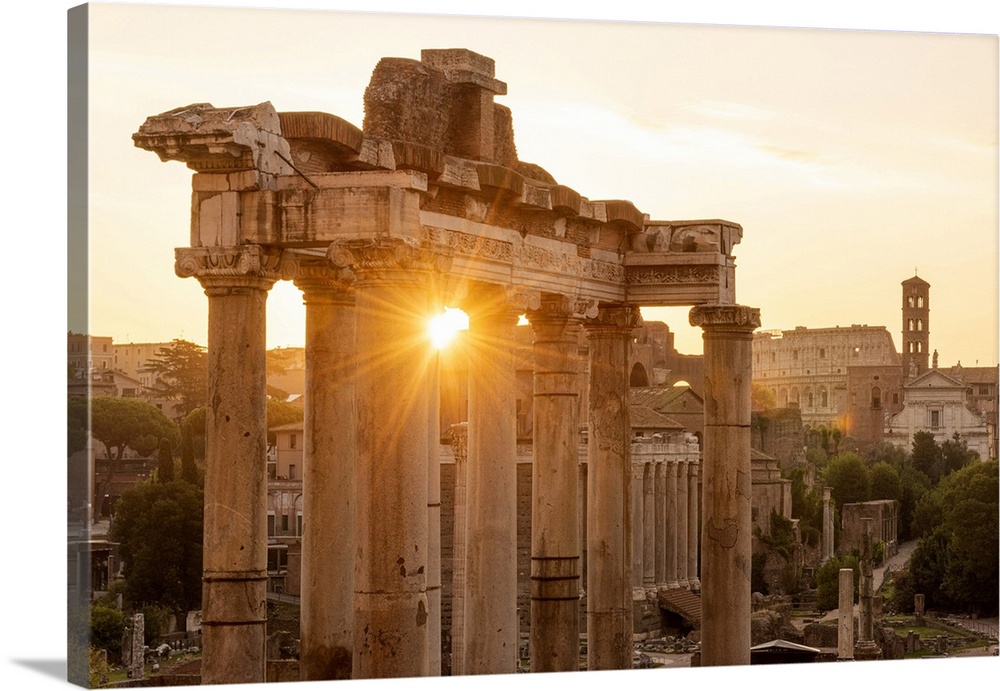 Europe, Italy, Rome. The Forum Romanum with the temple of Saturn in the rising sun.