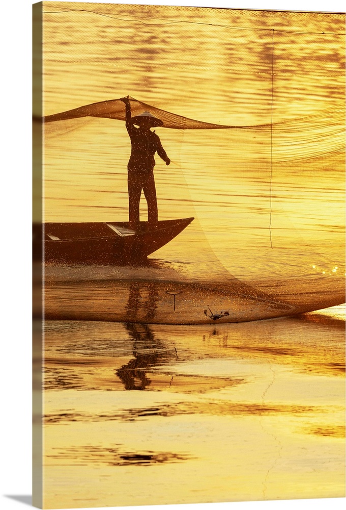 Fisherman working on the nets at sunrise, Thu Bon River, Quang Nam Province, Vietnam.