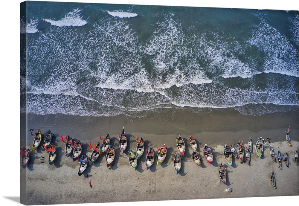 Aerial view of traditional fishing boats along the shoreline on the beach on Teknaf, Cox's Bazar, Chittagong, Bangladesh.