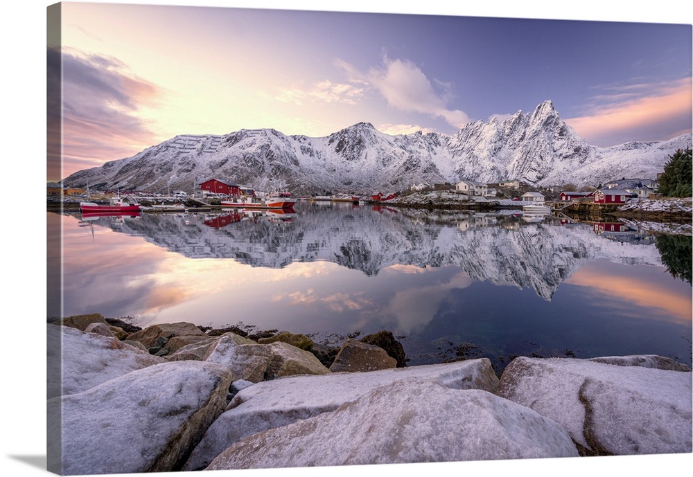 Fishing village of Ballstad and snowy mountains reflected in the sea at dawn, Vestvagoy, Lofoten Islands, Norway