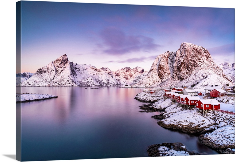 Fishing village of Hamnoy and snowy mountains under a colorful sky at sunrise, Reine, Lofoten Islands, Norway