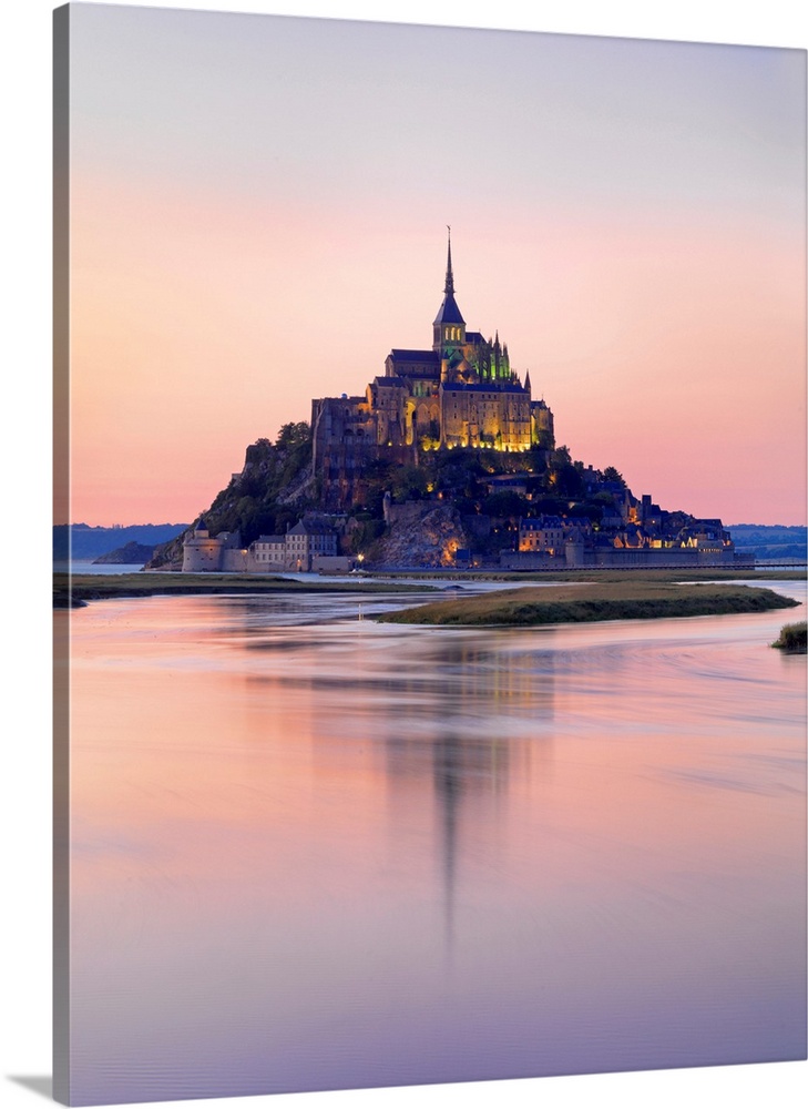 France, Normandy, Le Mont Saint Michel reflected in river at night.