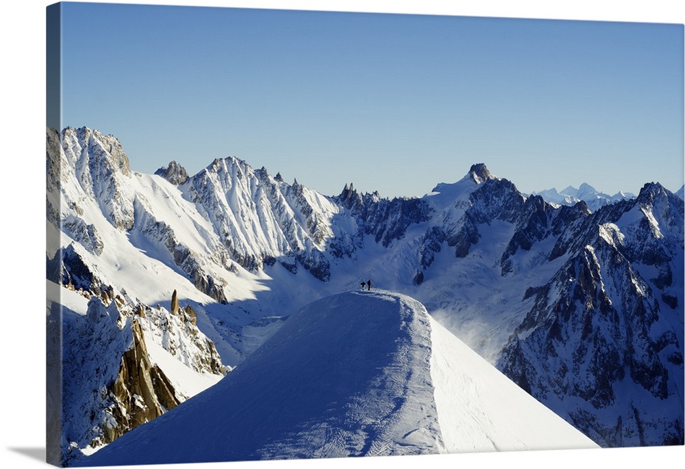 Europe, France, French Alps, Haute-Savoie, Chamonix, Aiguille du Midi, skiers walking down the ridge at the start of Valle...